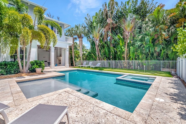 view of swimming pool featuring an in ground hot tub and a patio