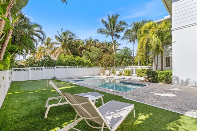 view of pool with a patio area and a lawn