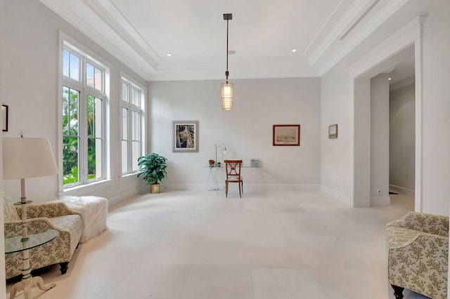 sitting room featuring a raised ceiling, ornamental molding, and light tile patterned floors