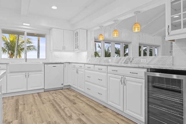 kitchen with wine cooler, white cabinetry, dishwasher, and plenty of natural light