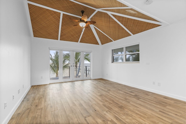 unfurnished room featuring french doors, light hardwood / wood-style floors, high vaulted ceiling, and ceiling fan