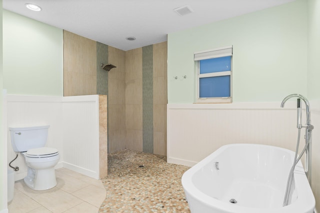 bathroom featuring tile patterned floors, separate shower and tub, and toilet