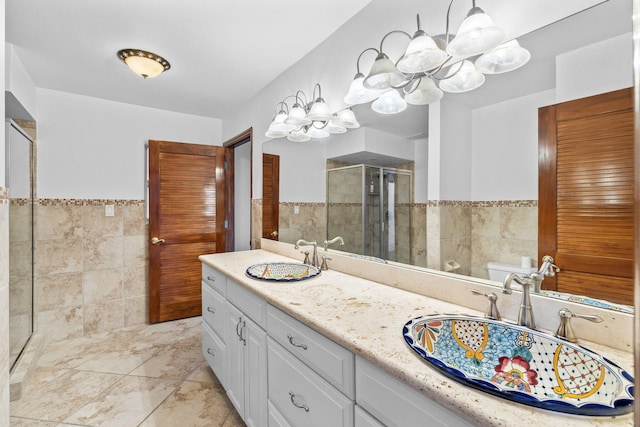 bathroom with vanity, tile walls, and toilet