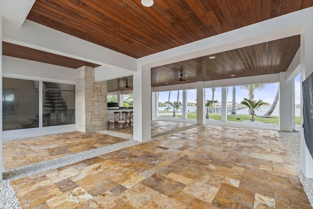 view of patio with exterior bar and ceiling fan