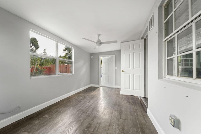 unfurnished room with ceiling fan, dark hardwood / wood-style flooring, and lofted ceiling