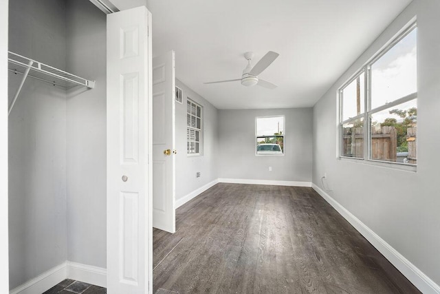 unfurnished bedroom featuring ceiling fan and dark hardwood / wood-style flooring