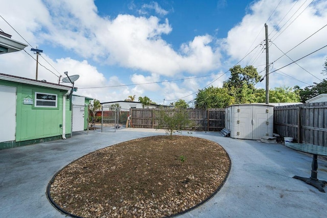 view of yard with a storage unit and a patio area