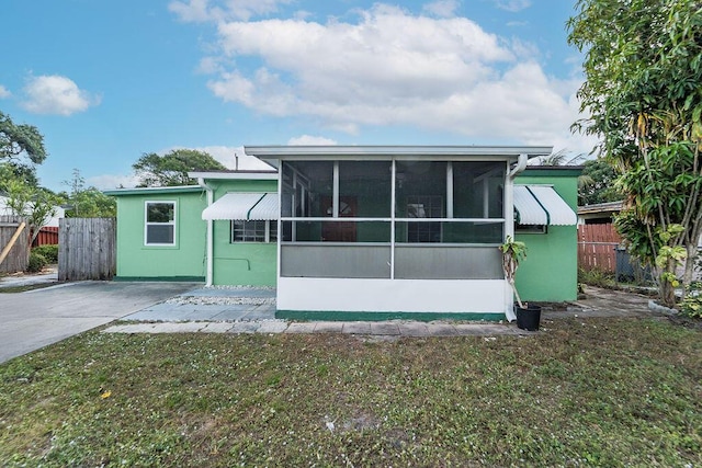 back of property with a sunroom