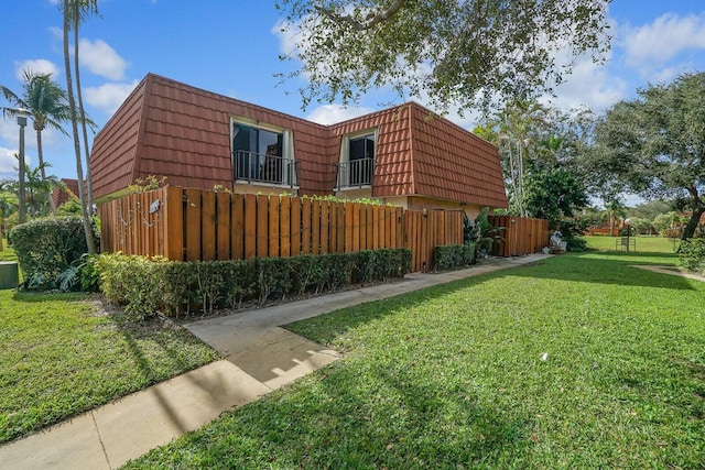 view of side of property with a yard