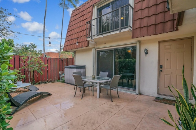 view of patio / terrace with a hot tub