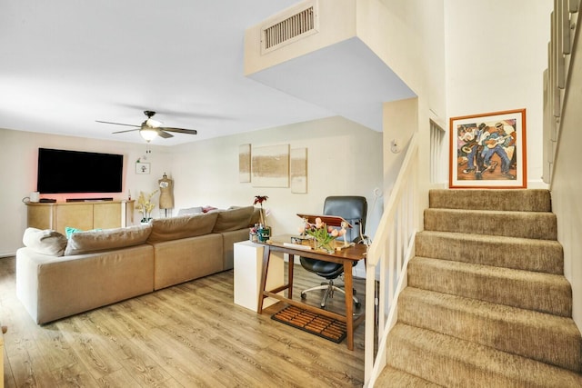 living room with ceiling fan and light wood-type flooring