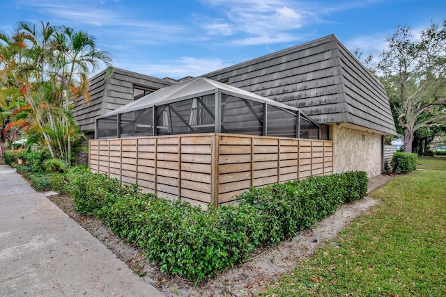 view of side of home featuring a lanai