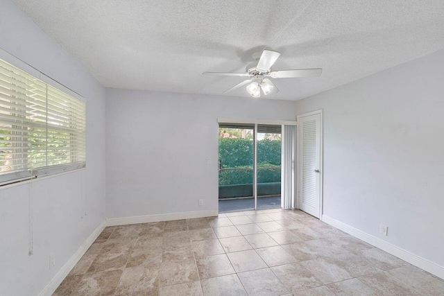 unfurnished room featuring ceiling fan and a textured ceiling