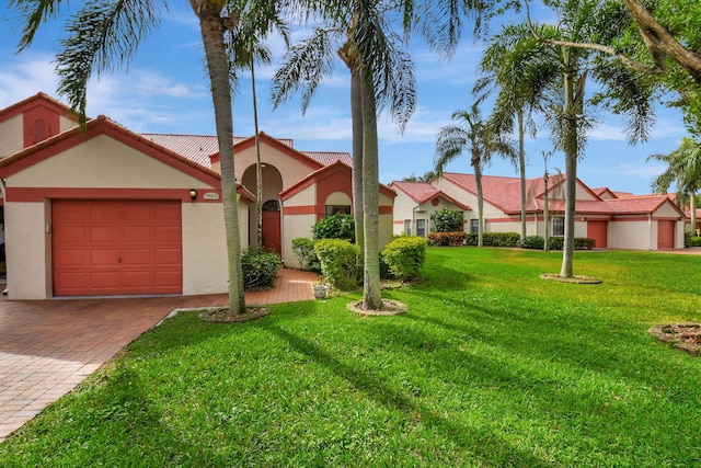 view of front of house with a front yard and a garage