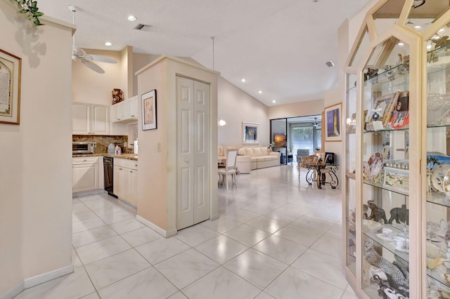 kitchen with white cabinets, light tile patterned floors, decorative backsplash, and ceiling fan