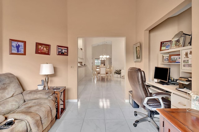 tiled office space with a notable chandelier and a high ceiling