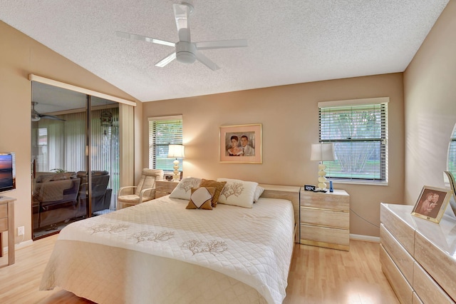 bedroom with ceiling fan, light wood-type flooring, multiple windows, and a closet