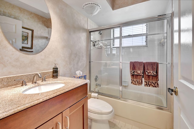 full bathroom with tile patterned flooring, vanity, toilet, and shower / bath combination with glass door