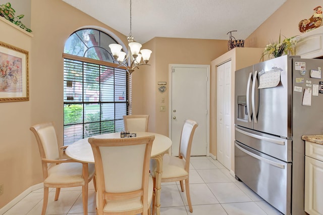 dining room featuring light tile patterned floors and a notable chandelier