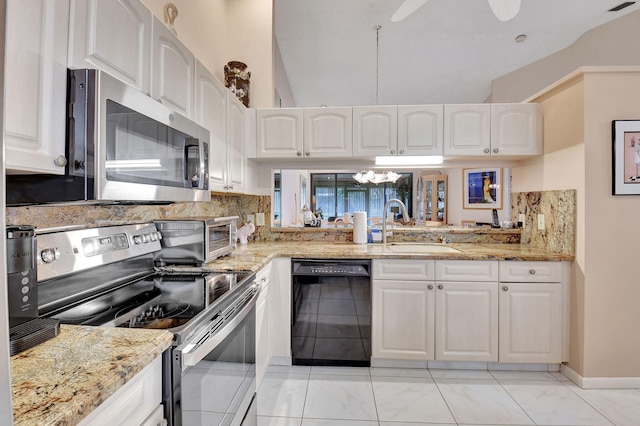7906 Lexington Club Blvd Unit B, Delray Beach, FL 33446 - kitchen with stainless steel appliances, decorative backsplash, white cabinets, light stone counters, and a chandelier