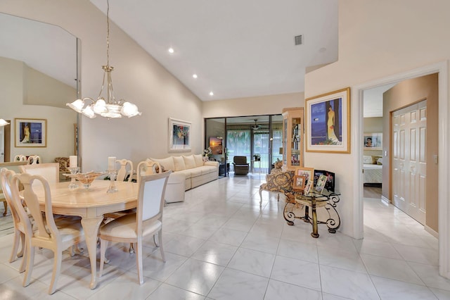 tiled dining space with a notable chandelier and high vaulted ceiling