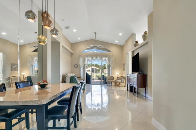 dining room featuring ceiling fan, lofted ceiling, and light tile patterned floors