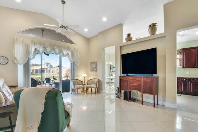 living room with ceiling fan, light tile patterned floors, and lofted ceiling