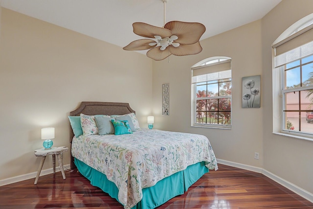 bedroom with ceiling fan and dark wood-type flooring