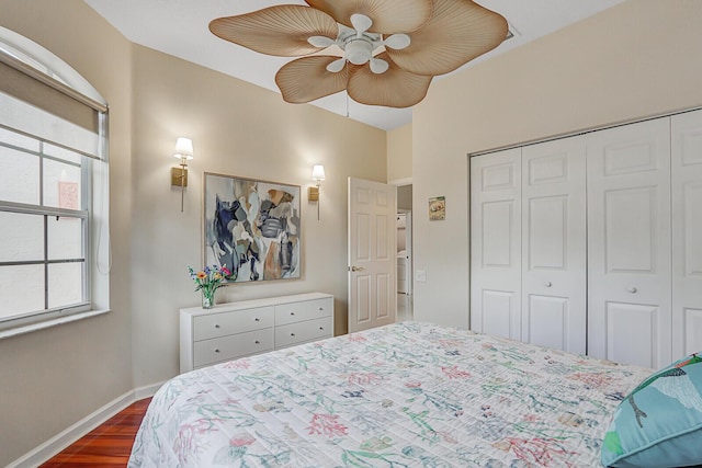 bedroom with ceiling fan, a closet, and dark hardwood / wood-style floors