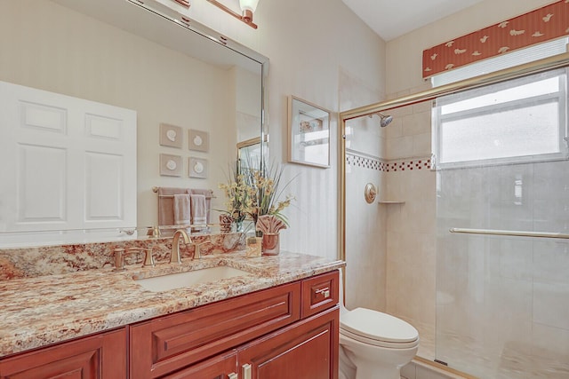 bathroom featuring vanity, toilet, and walk in shower