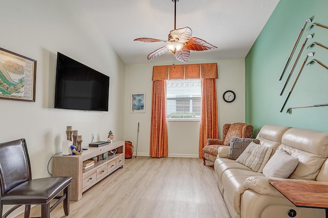 living room featuring ceiling fan, light wood-type flooring, and lofted ceiling