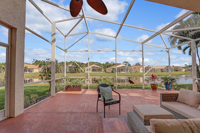 exterior space with an outdoor living space, a water view, ceiling fan, and a lanai