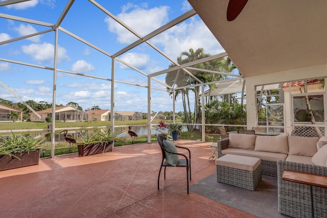 view of patio / terrace with a lanai, outdoor lounge area, and a water view