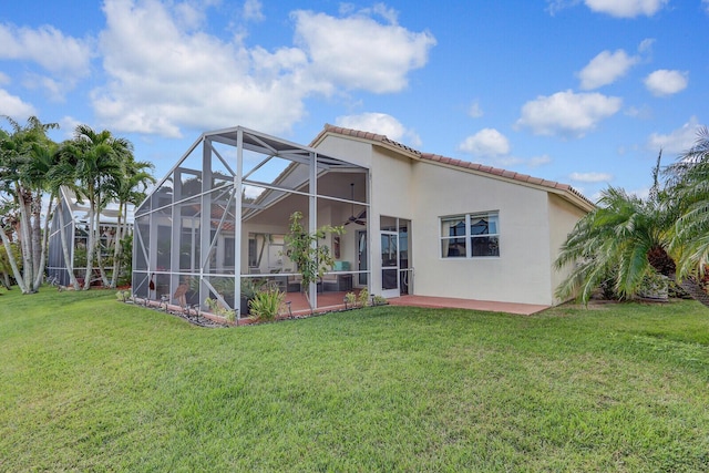 back of house featuring a lanai, a yard, and a patio