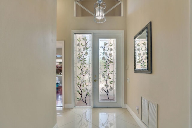 tiled foyer entrance featuring a high ceiling