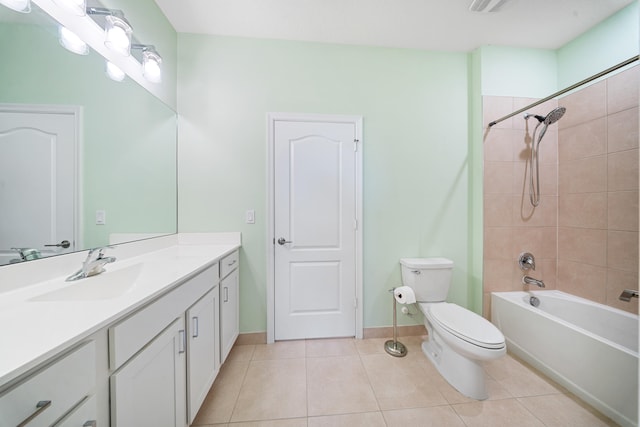 full bathroom featuring toilet, tile patterned flooring, vanity, and tiled shower / bath