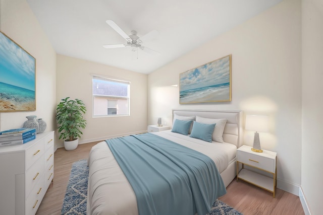 bedroom with ceiling fan and light wood-type flooring