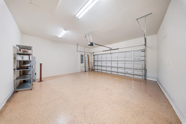 garage featuring electric panel and a garage door opener