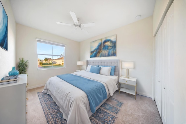 carpeted bedroom featuring a closet and ceiling fan