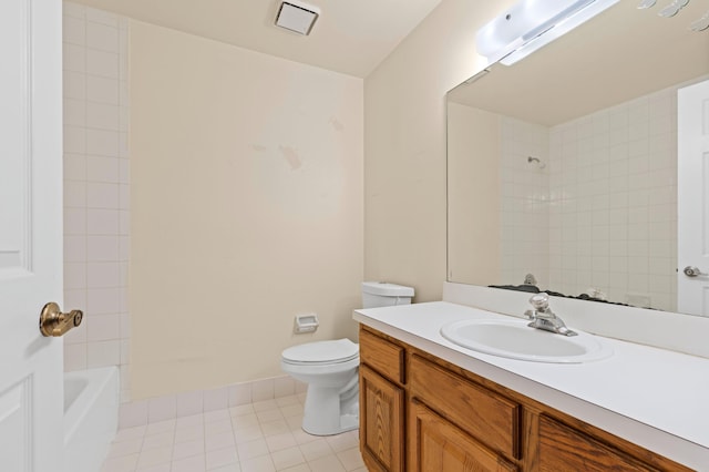 full bathroom featuring vanity, tile patterned flooring, tiled shower / bath combo, and toilet