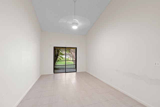 spare room with light tile patterned flooring and a textured ceiling