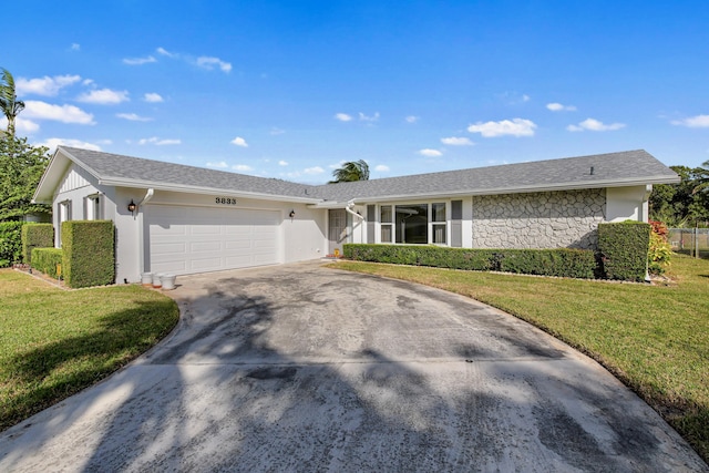 ranch-style home with a front yard and a garage