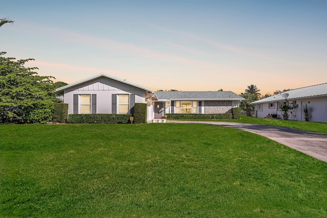 ranch-style house featuring a yard