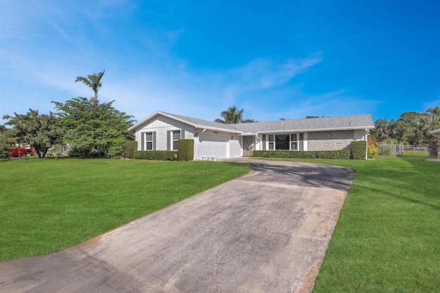 ranch-style house with a front yard and a garage