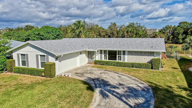 single story home with a front yard and a garage