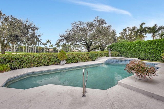 view of swimming pool with an in ground hot tub