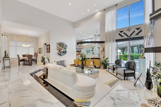 living room featuring a high ceiling and an inviting chandelier