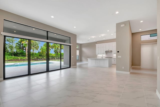 unfurnished living room with sink and french doors