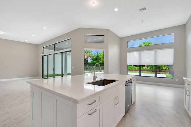 kitchen with white cabinets, an island with sink, dishwasher, and sink