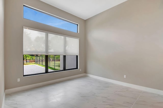 unfurnished room featuring plenty of natural light